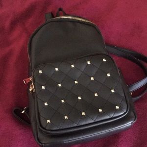 Black and gold mini book bag